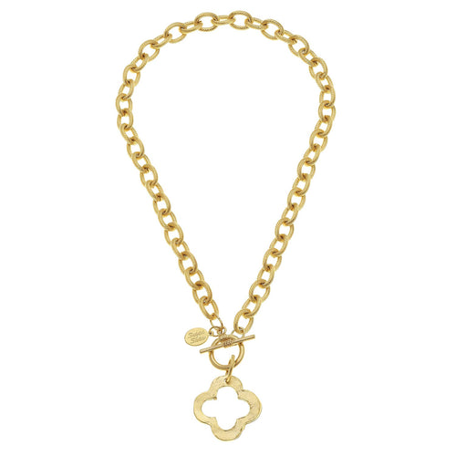 Gold chain necklace with a clover-shaped pendant on a white background