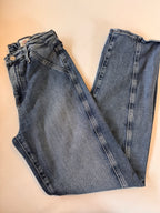 Pair of blue jeans on a beige background
