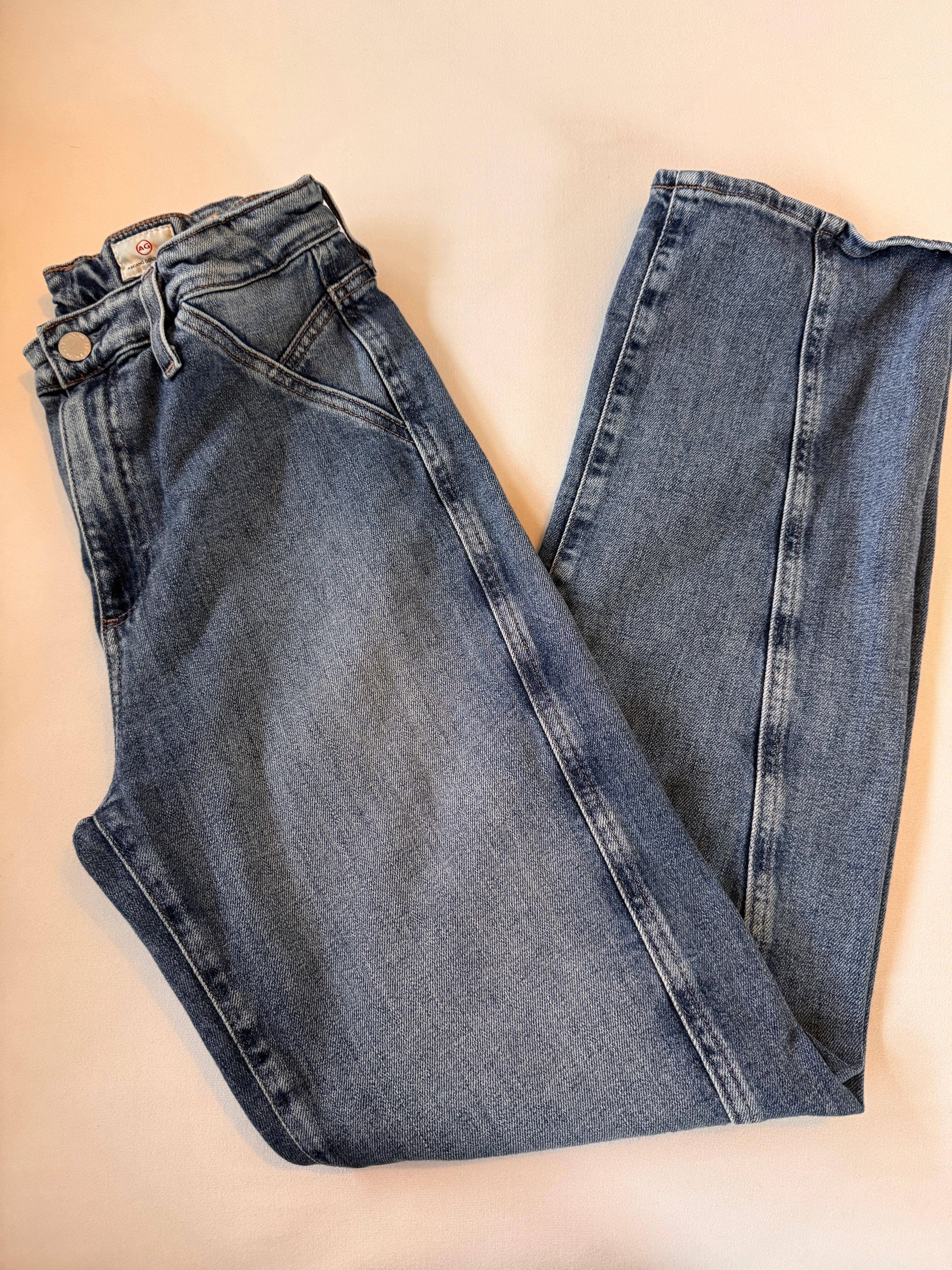 Pair of blue jeans on a beige background