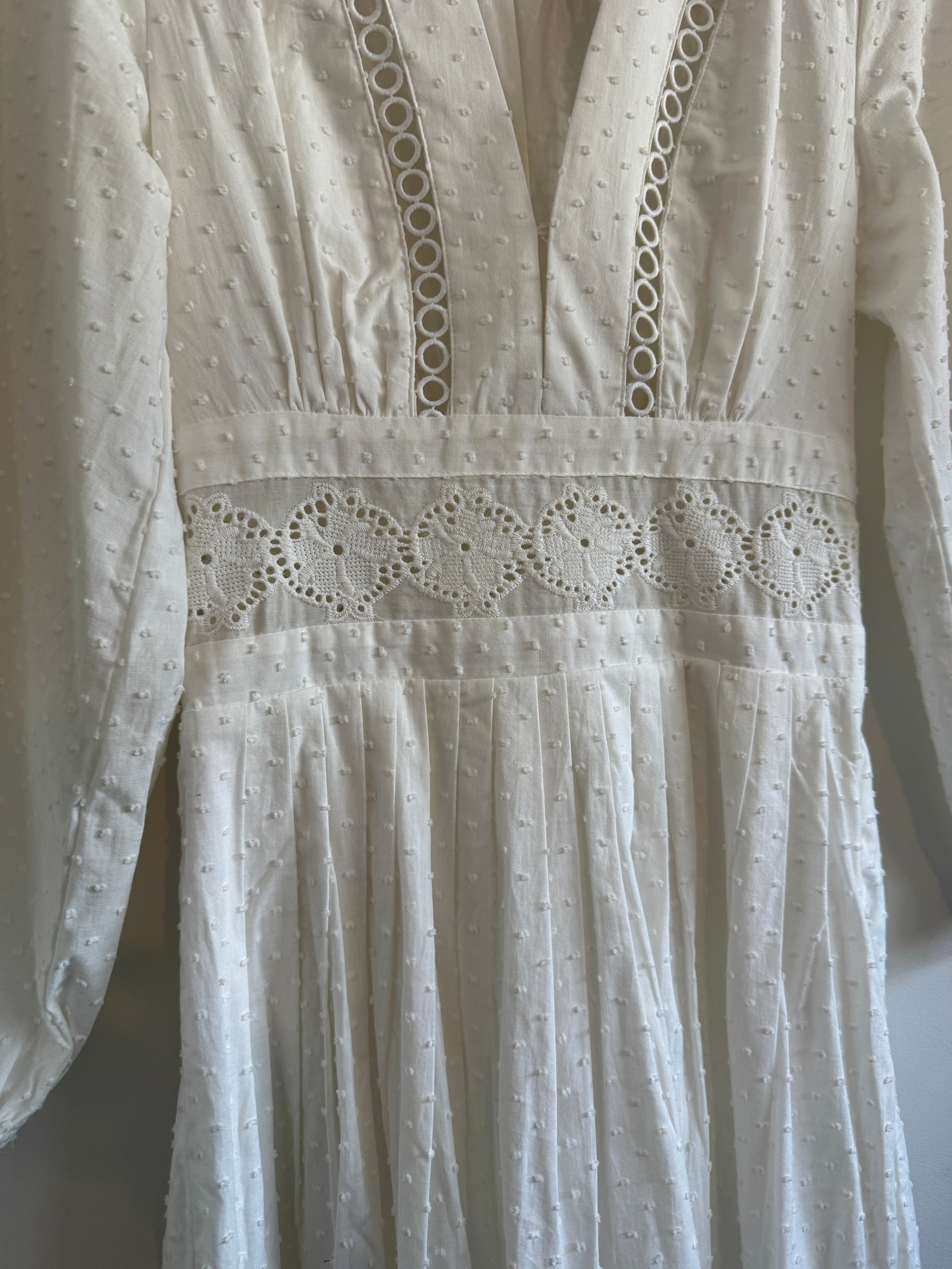 Close-up of a white embroidered fabric with intricate patterns