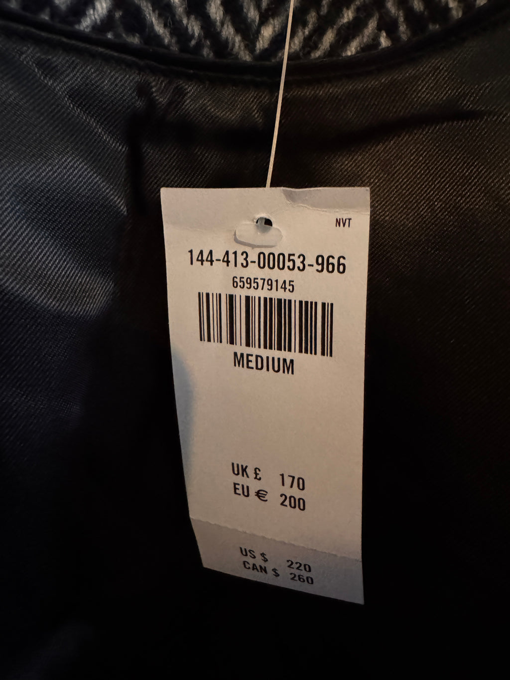 Clothing tag on a dark fabric background