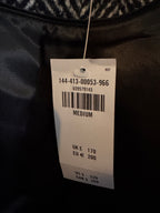 Clothing tag on a dark fabric background