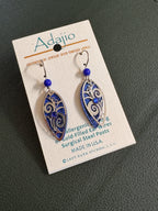 Silver and blue earrings with a bead and rhinestone on a card labeled Adajio