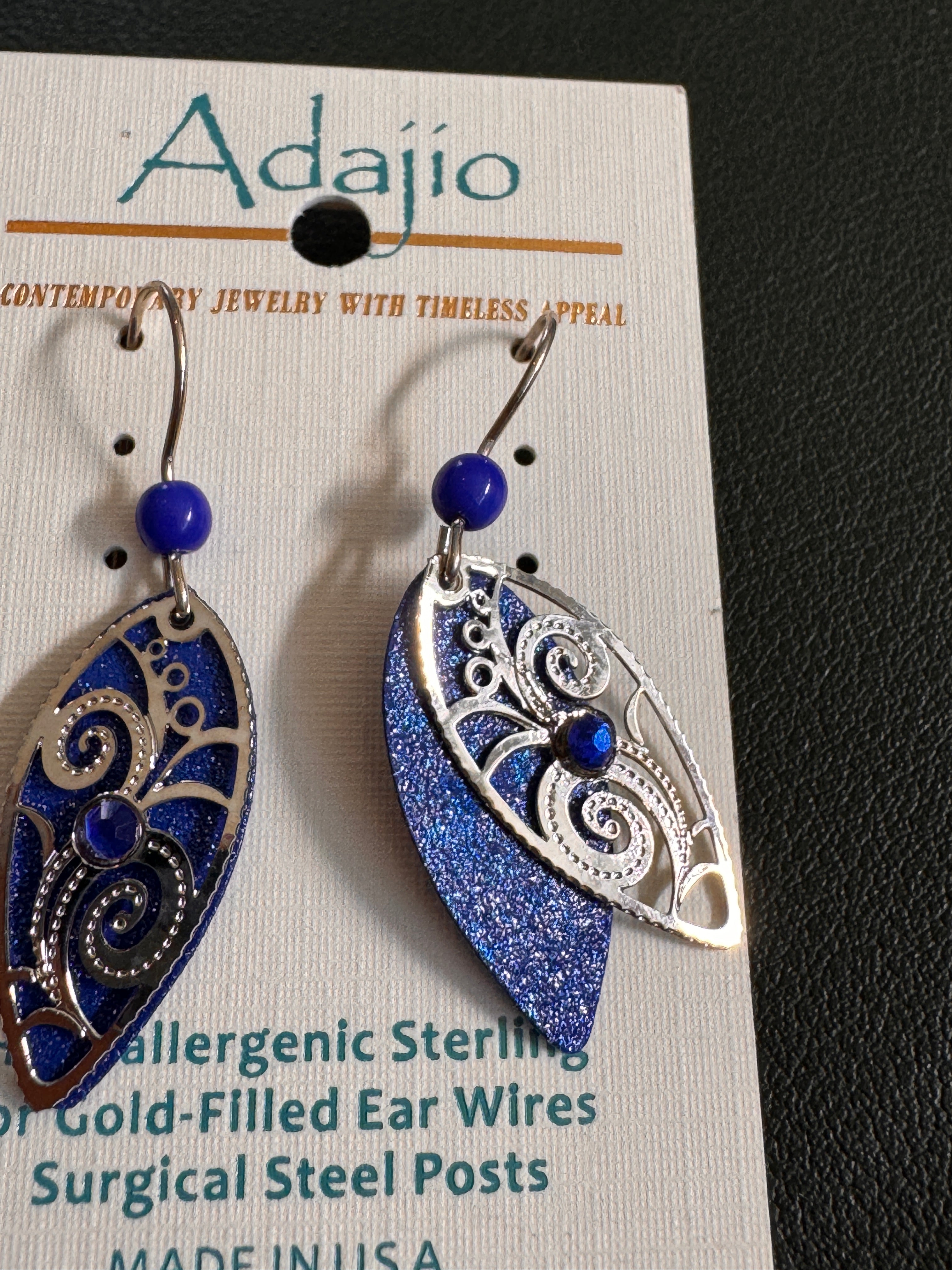 Blue and silver earrings on an Adajio jewelry card.