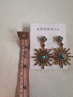 Sun-shaped earrings with turquoise stones on an Adornia card, measured against a ruler.