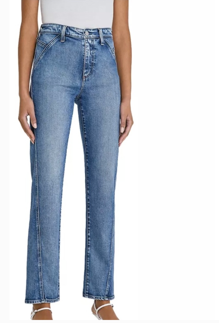 Blue jeans worn by a person on a white background