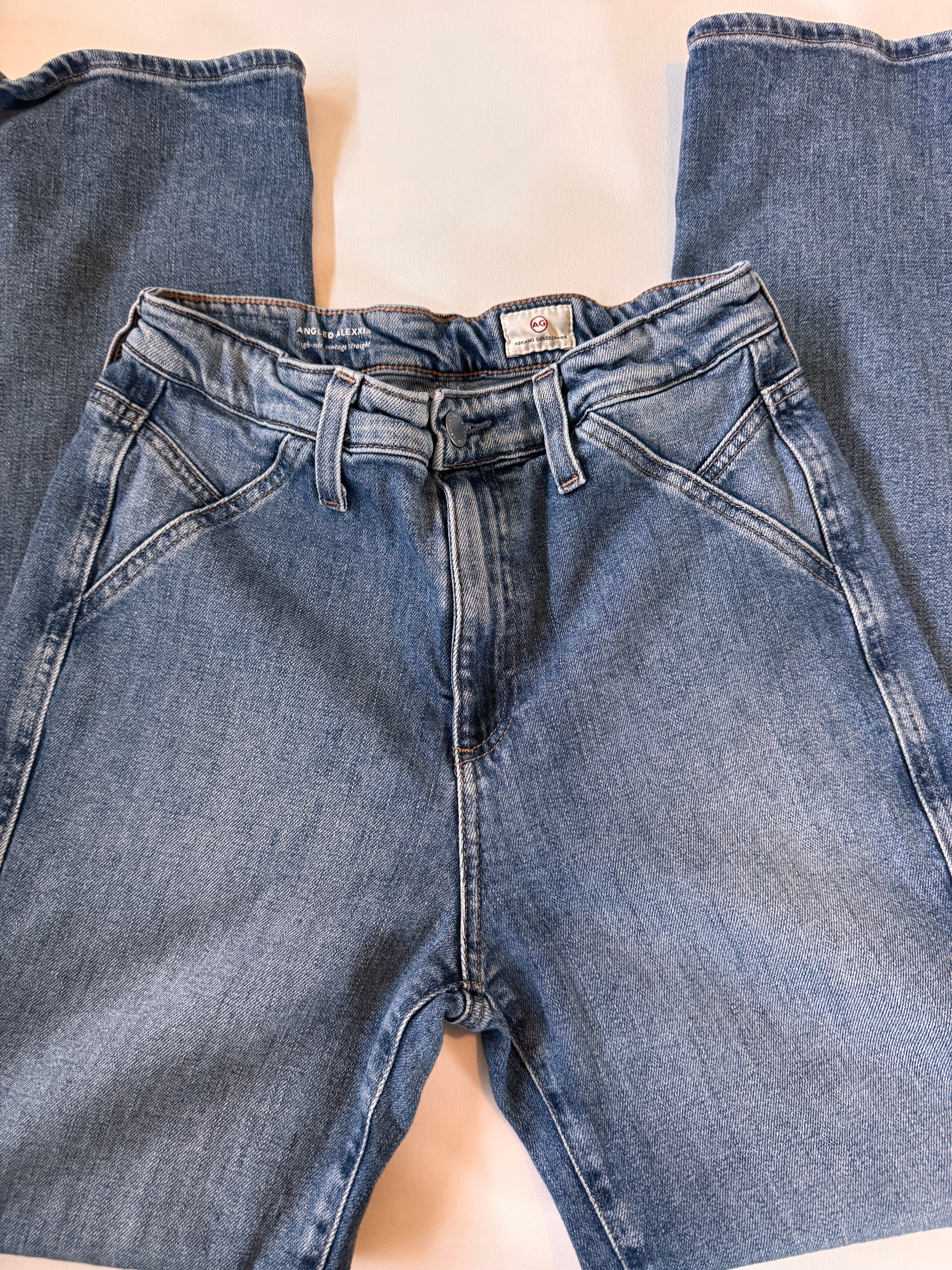 Close-up of blue jeans on a beige surface