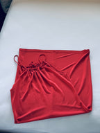 Coral dress with drawstring top on a white surface