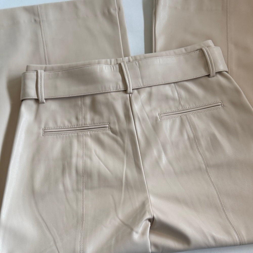 Beige leather pants with a belt on a light background