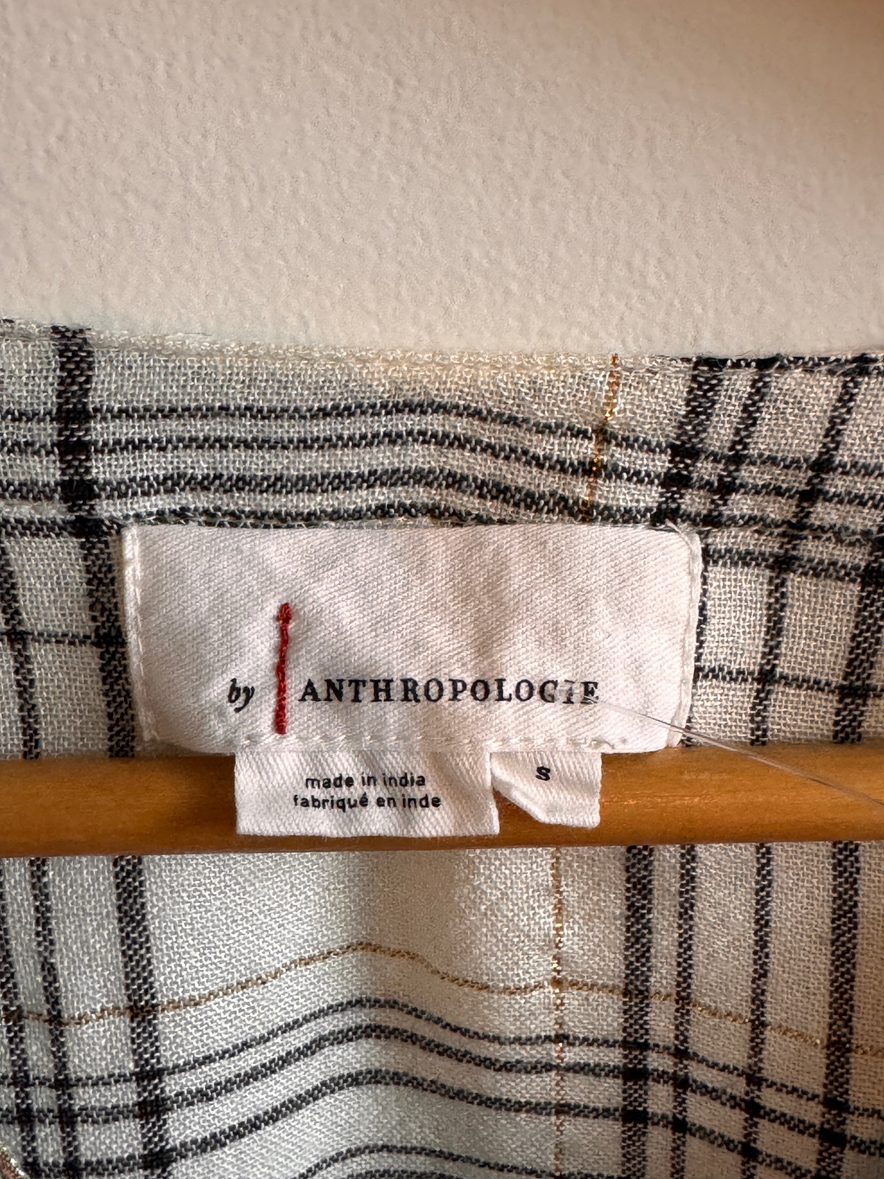 Close-up of a plaid fabric with an Anthropologie label.
