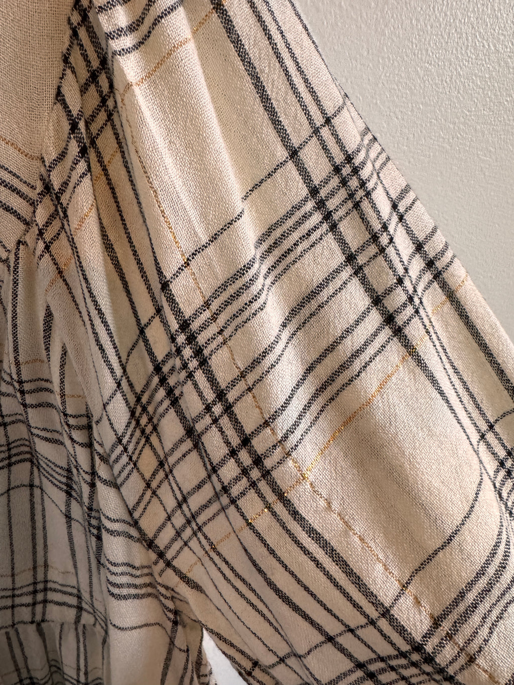 Close-up of beige fabric with black plaid pattern