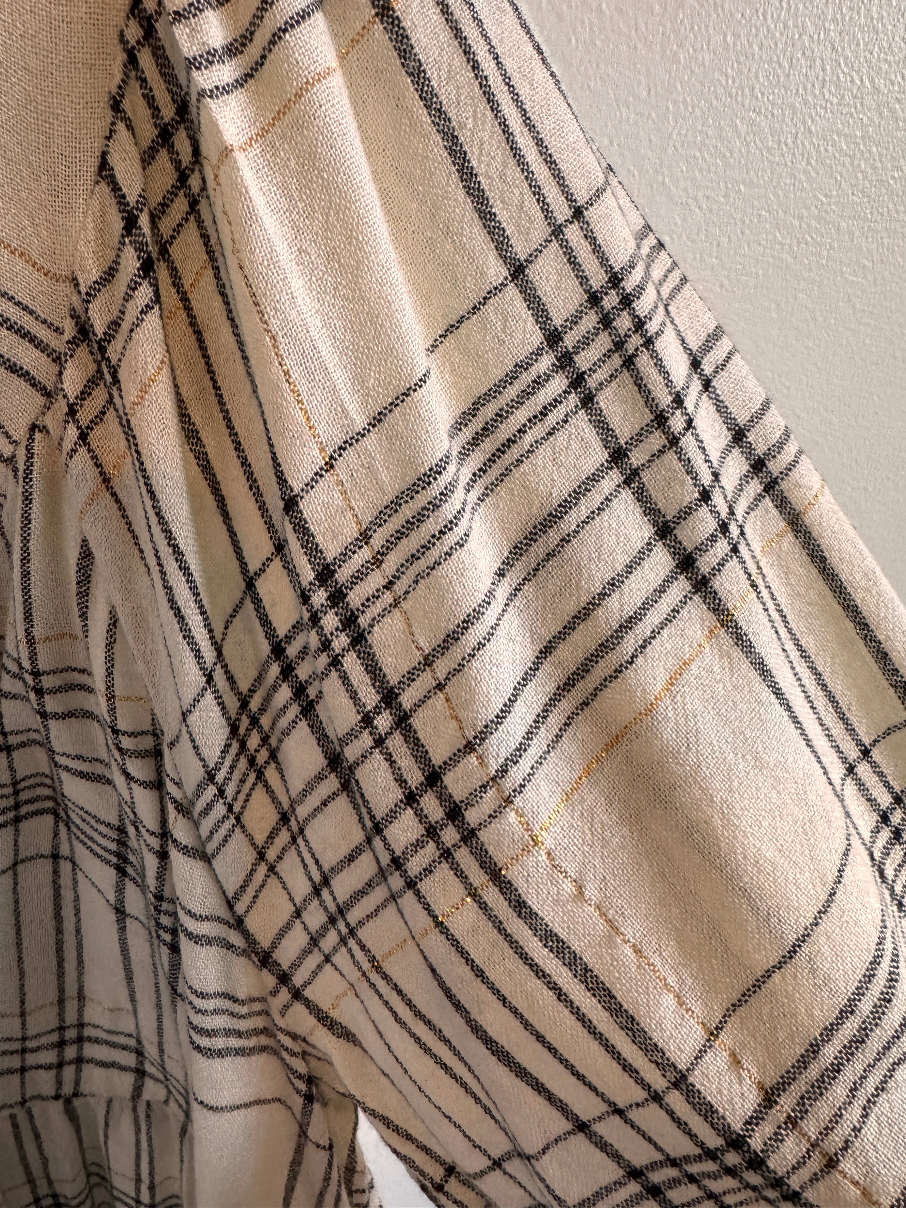 Close-up of beige fabric with black plaid pattern