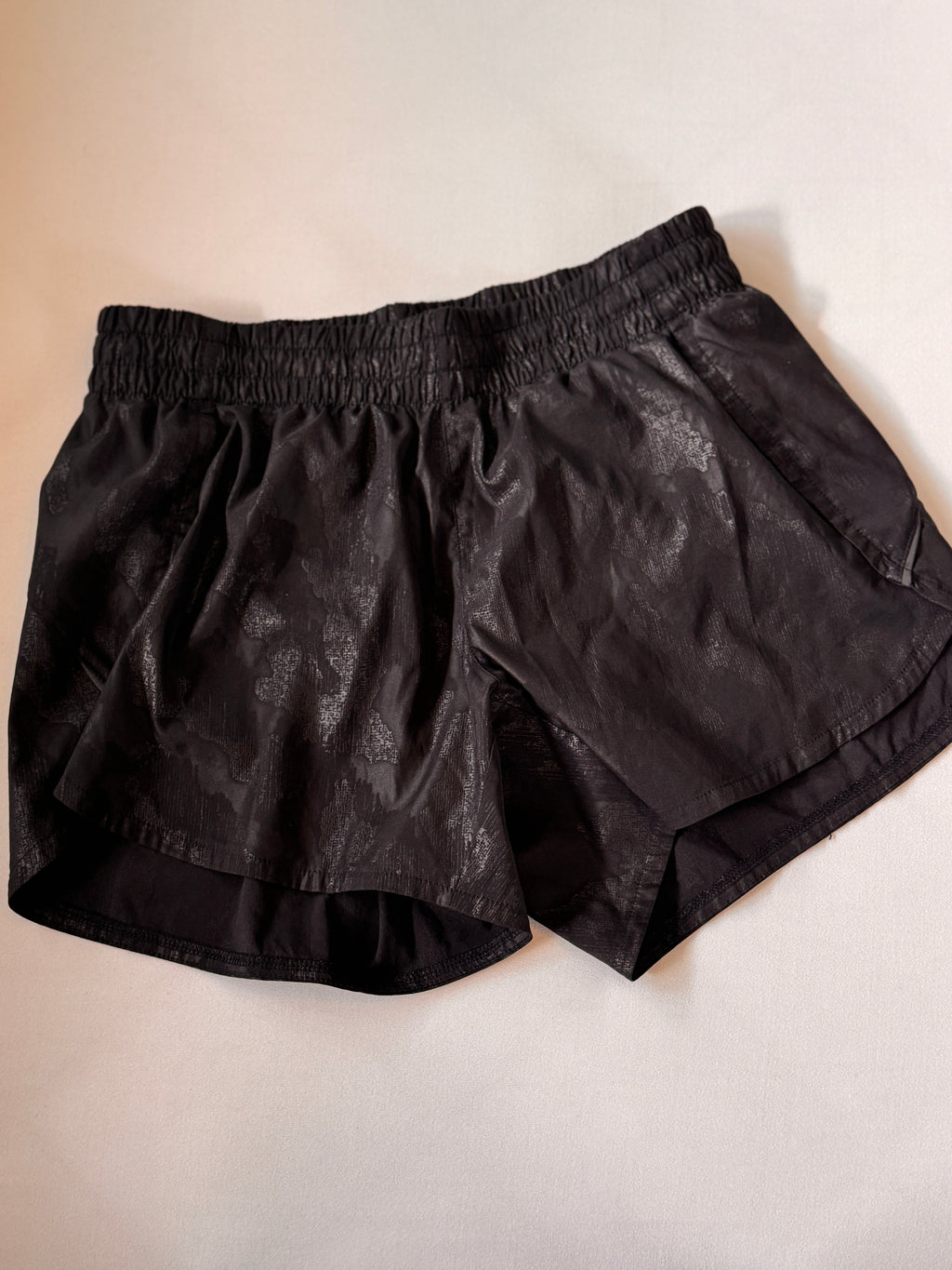 Black shorts on a light beige background
