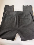 Folded gray pants on a white background