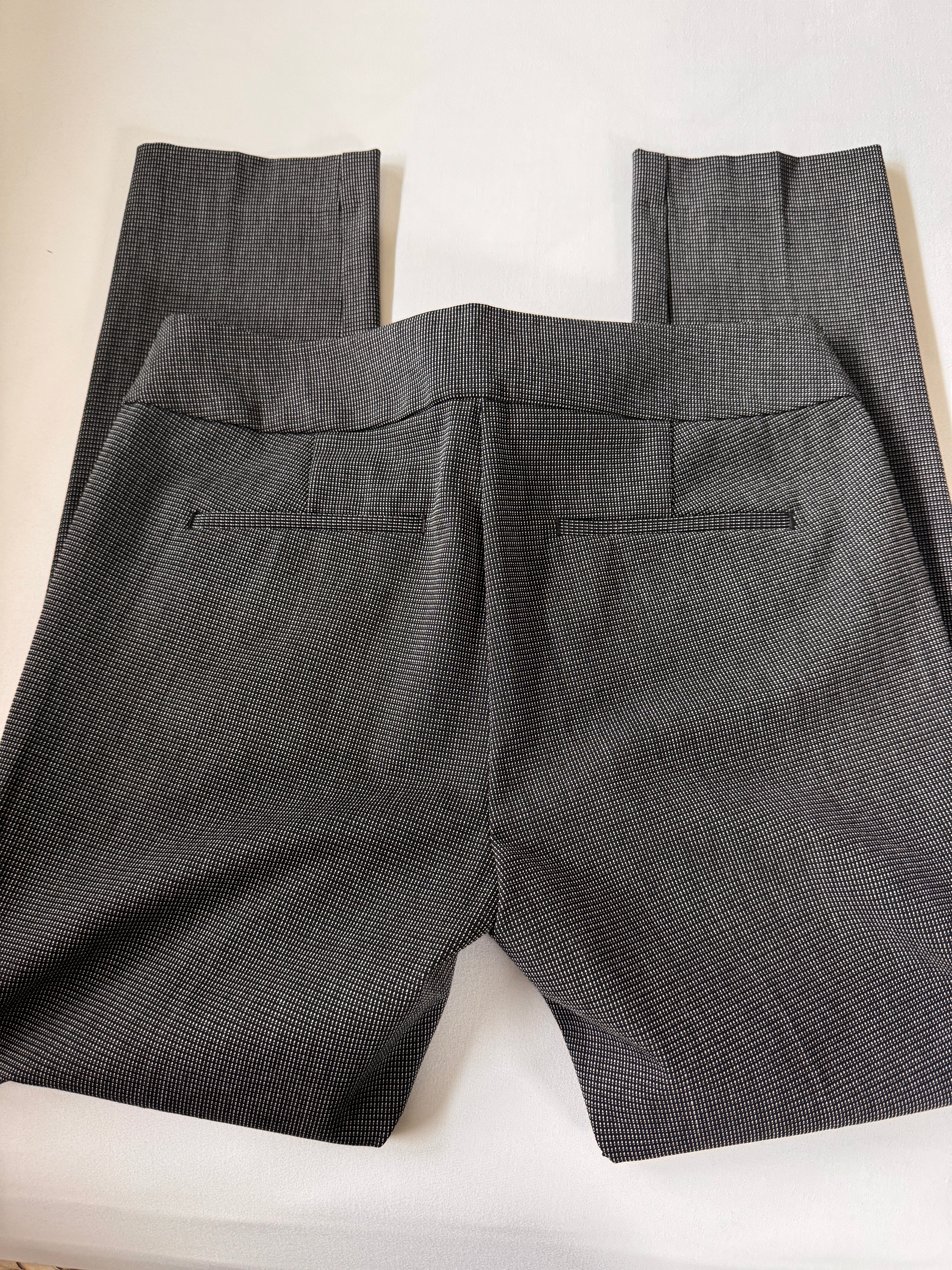 Folded gray pants on a white background