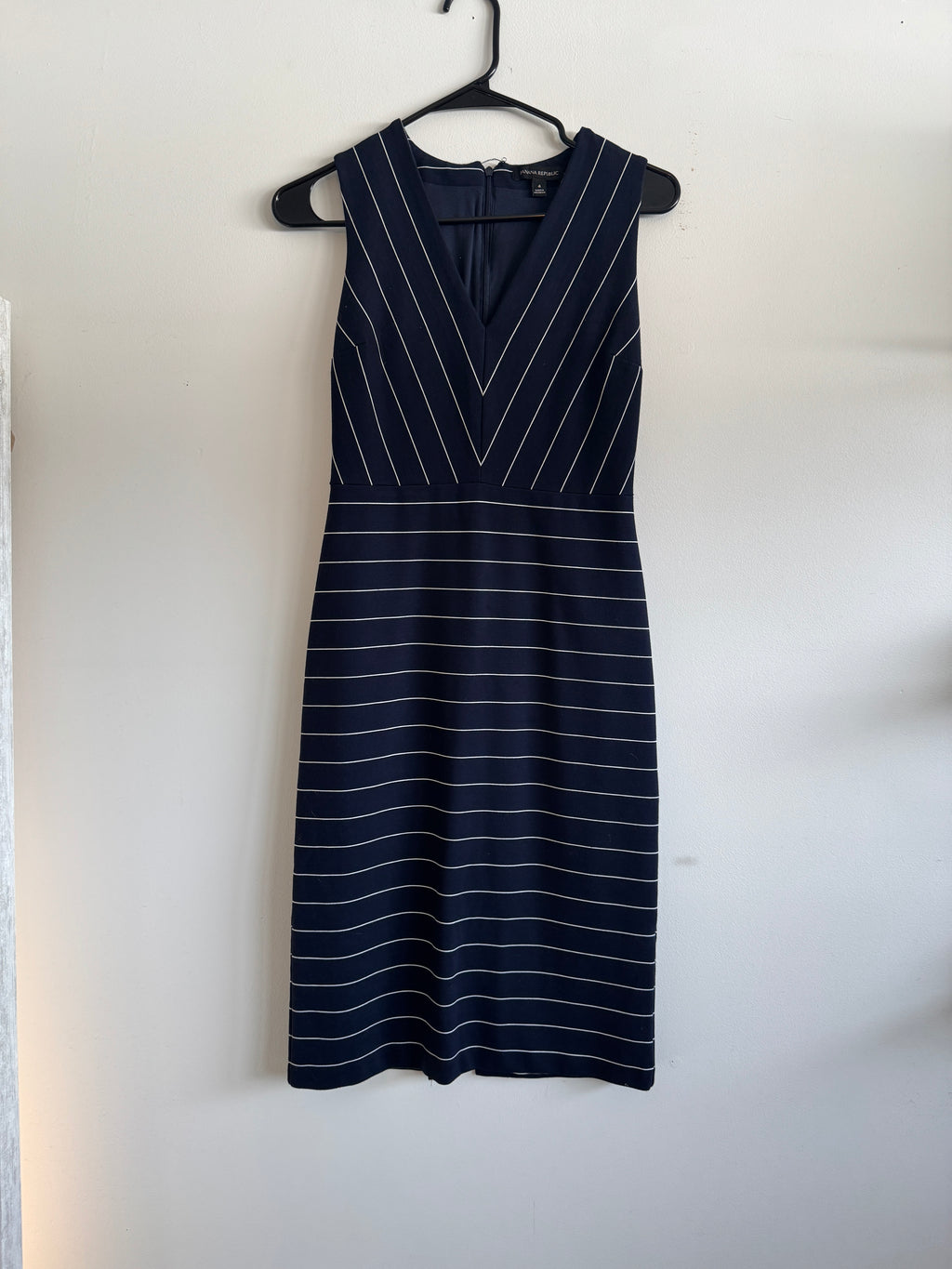 Navy pinstripe dress on a white background