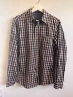 Plaid shirt on a hanger against a white wall