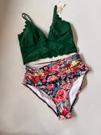 Green bikini top and floral patterned bottom on a light gray background