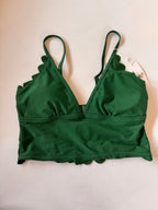 Green bikini top on a light beige background