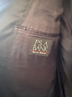 Close-up of anavy  jacket lining pocket with a sewn-on brand label reading 'Jos. A.
