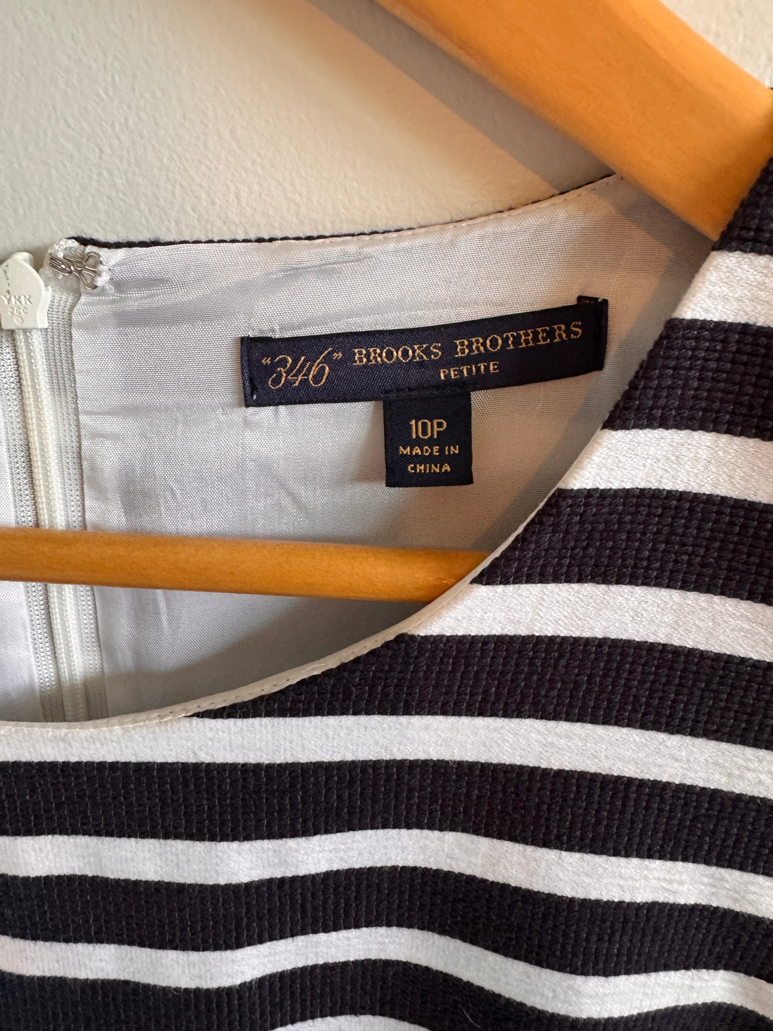 Size and brand labels inside of striped dress