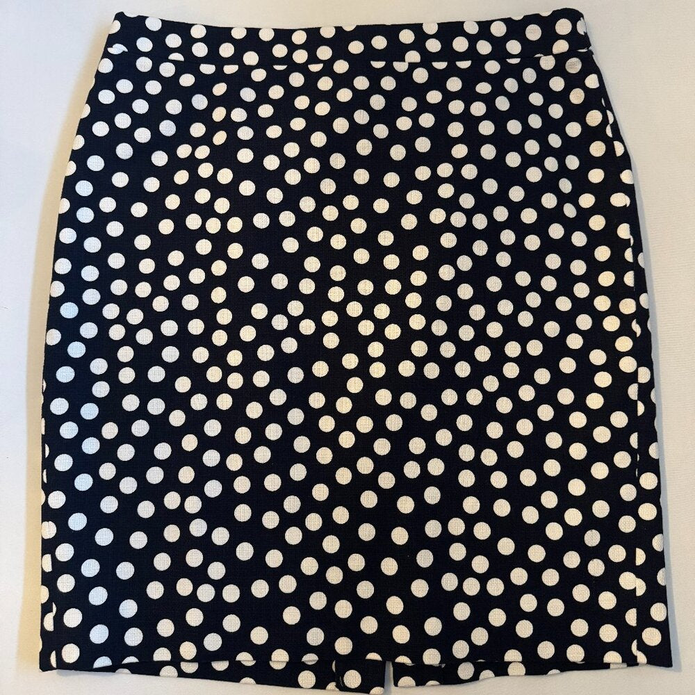 Black skirt with white polka dot pattern on a light gray background