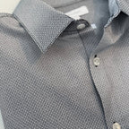 Close-up of a gray patterned shirt with collar and buttons.