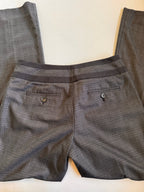 Gray checkered pants with button details on a light background