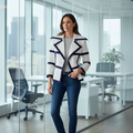 Woman wearing white blazer with navy trim and 3/4 sleeves in office