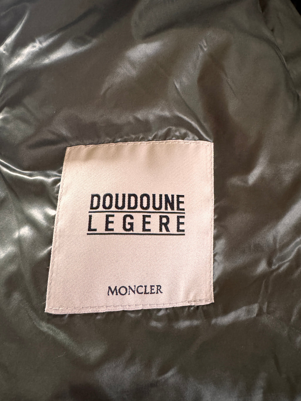 Moncler label on a dark fabric background