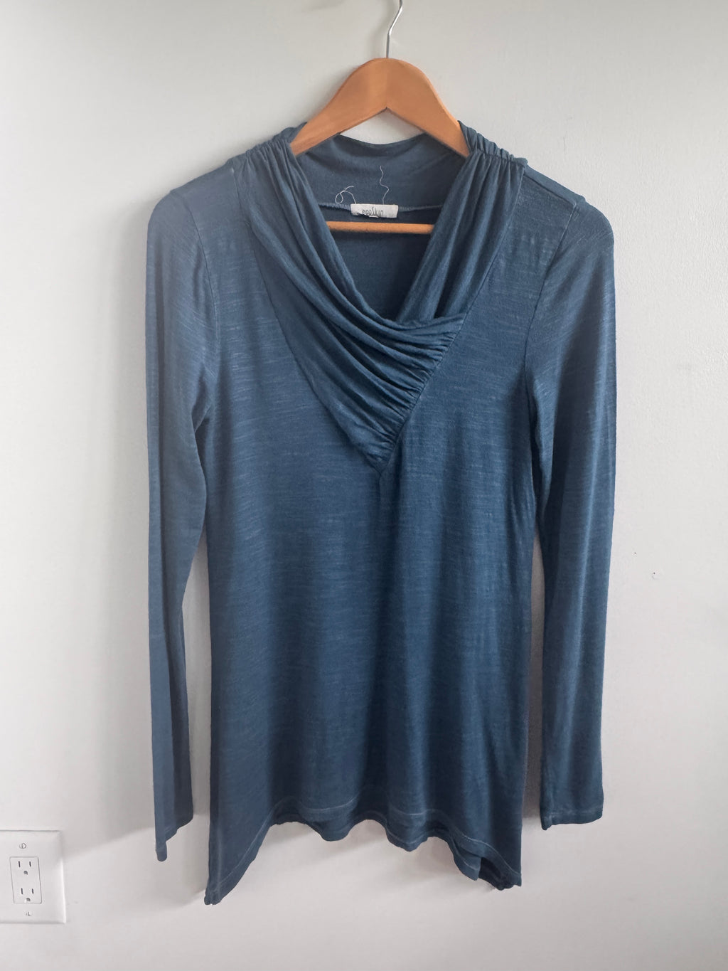 Blue dress on a hanger against a white background