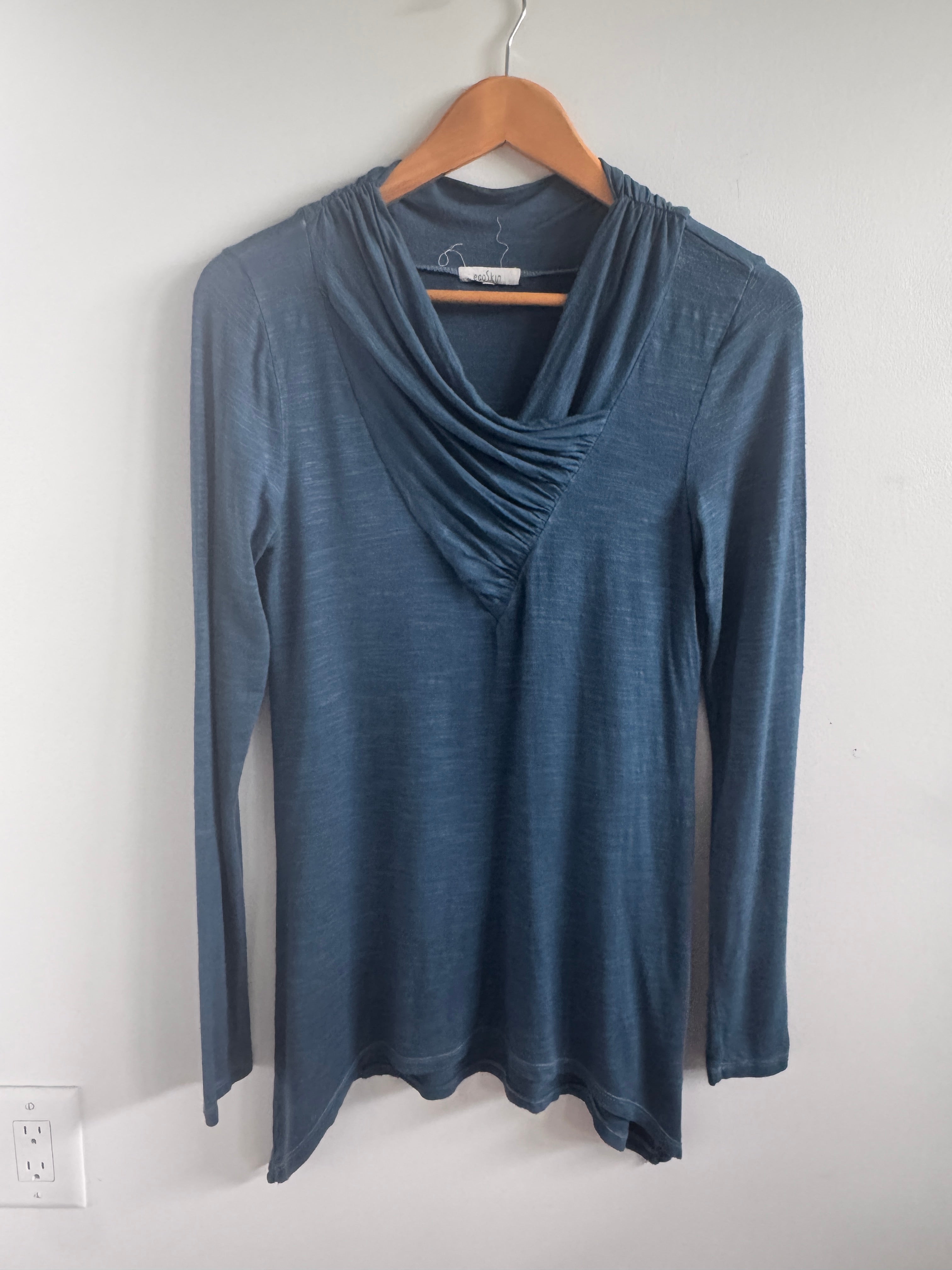 Blue dress on a hanger against a white background