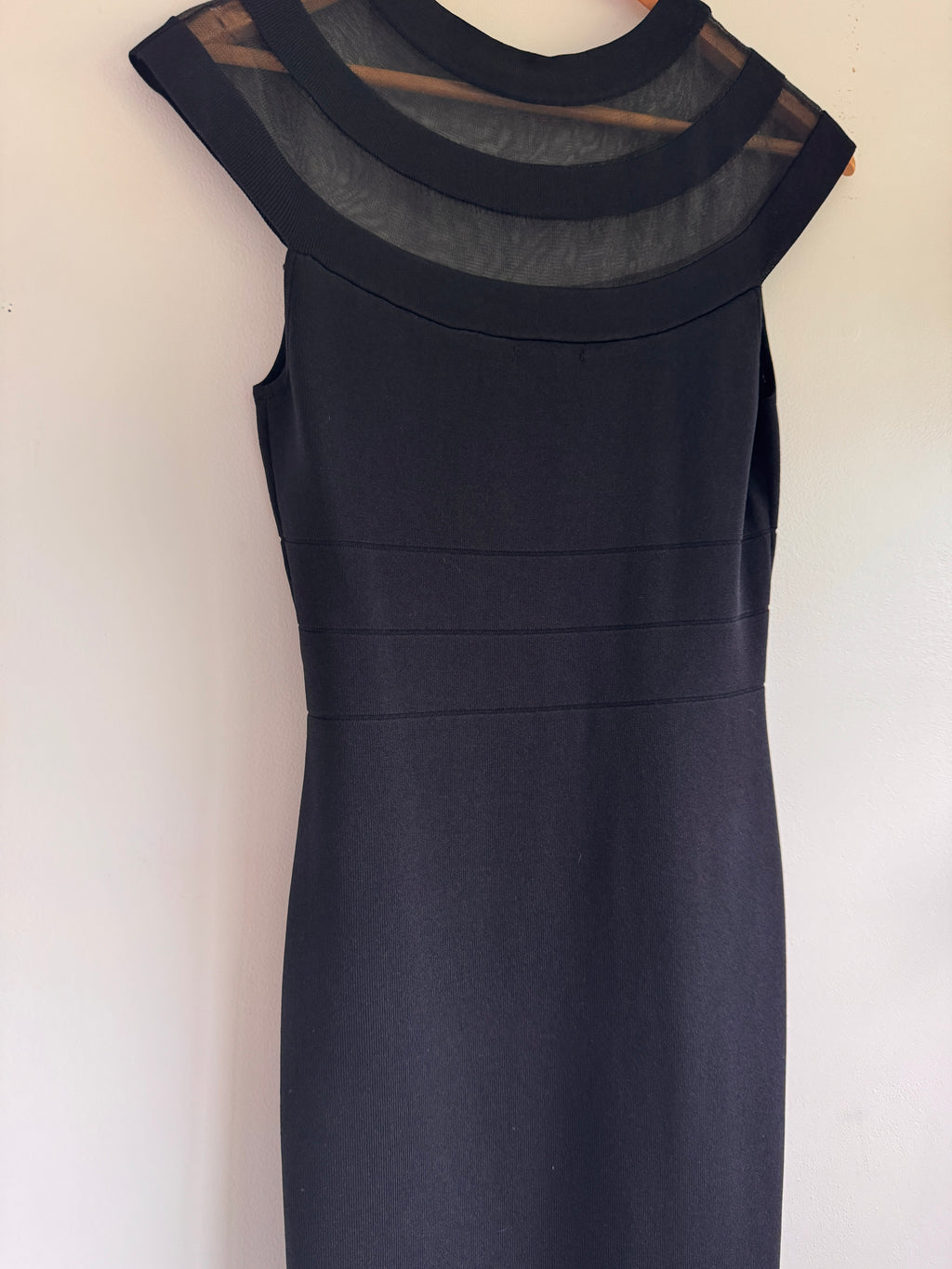 Black dress with sheer details on a white background