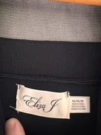 Close-up of a black garment with a visible brand label.