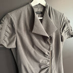 Gray short-sleeve dress with ruched details on a hanger against a neutral background