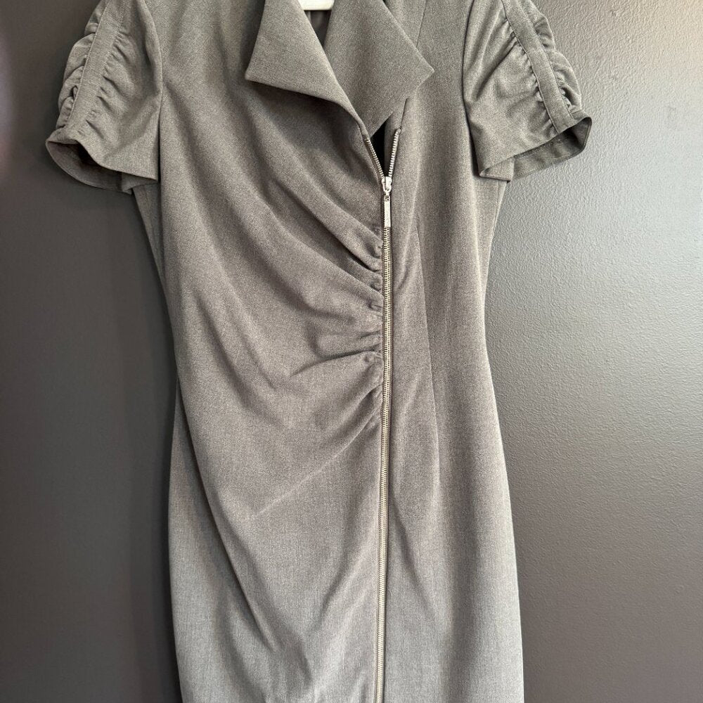 Gray dress with short sleeves and a zipper on a plain background