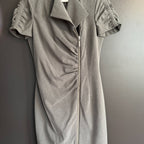 Gray dress with short sleeves and a zipper on a plain background