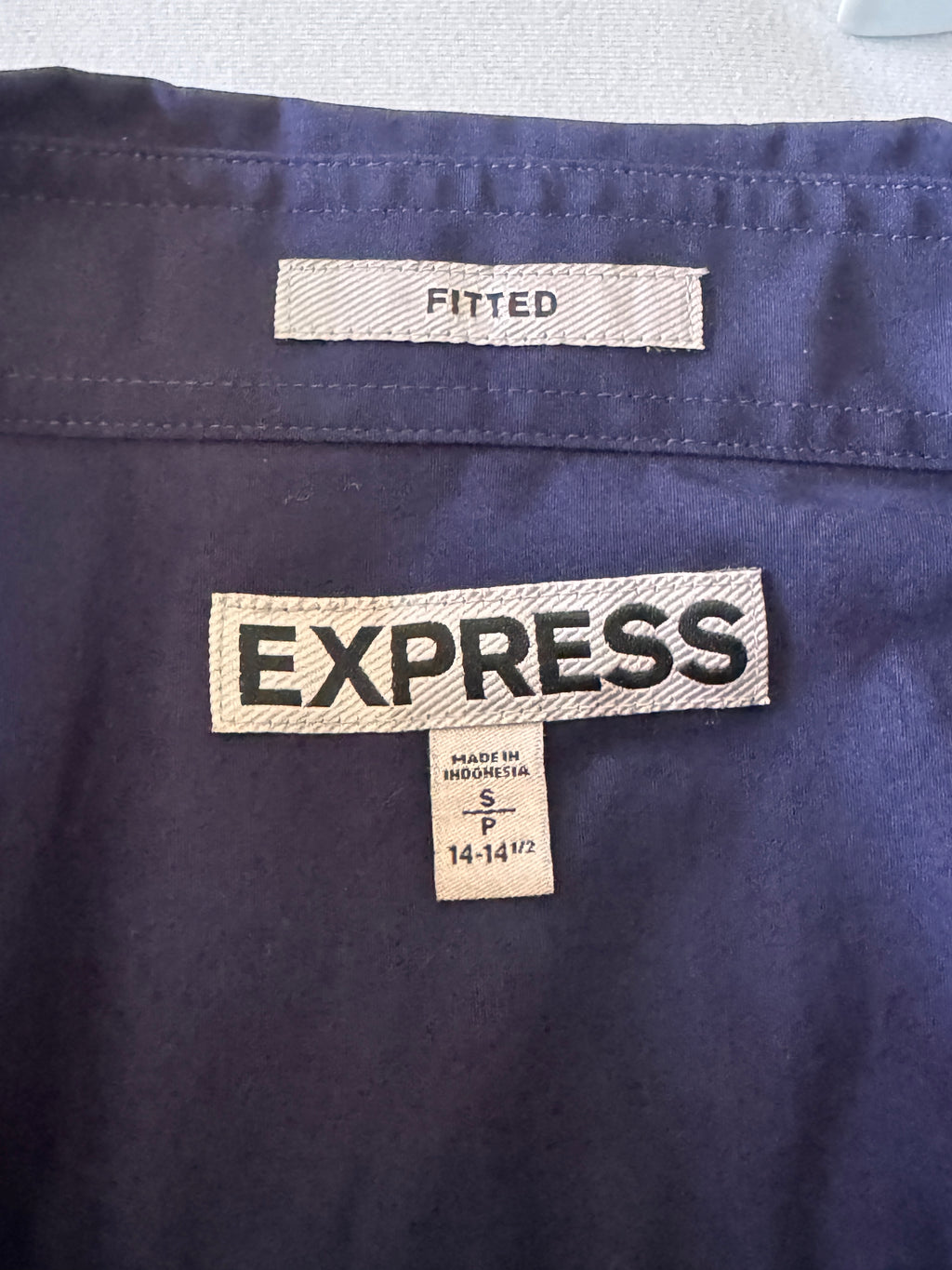 Close-up of Express clothing label on a navy fabric background