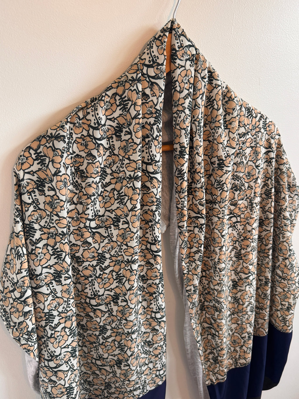 Folded floral-patterned fabric on a light background