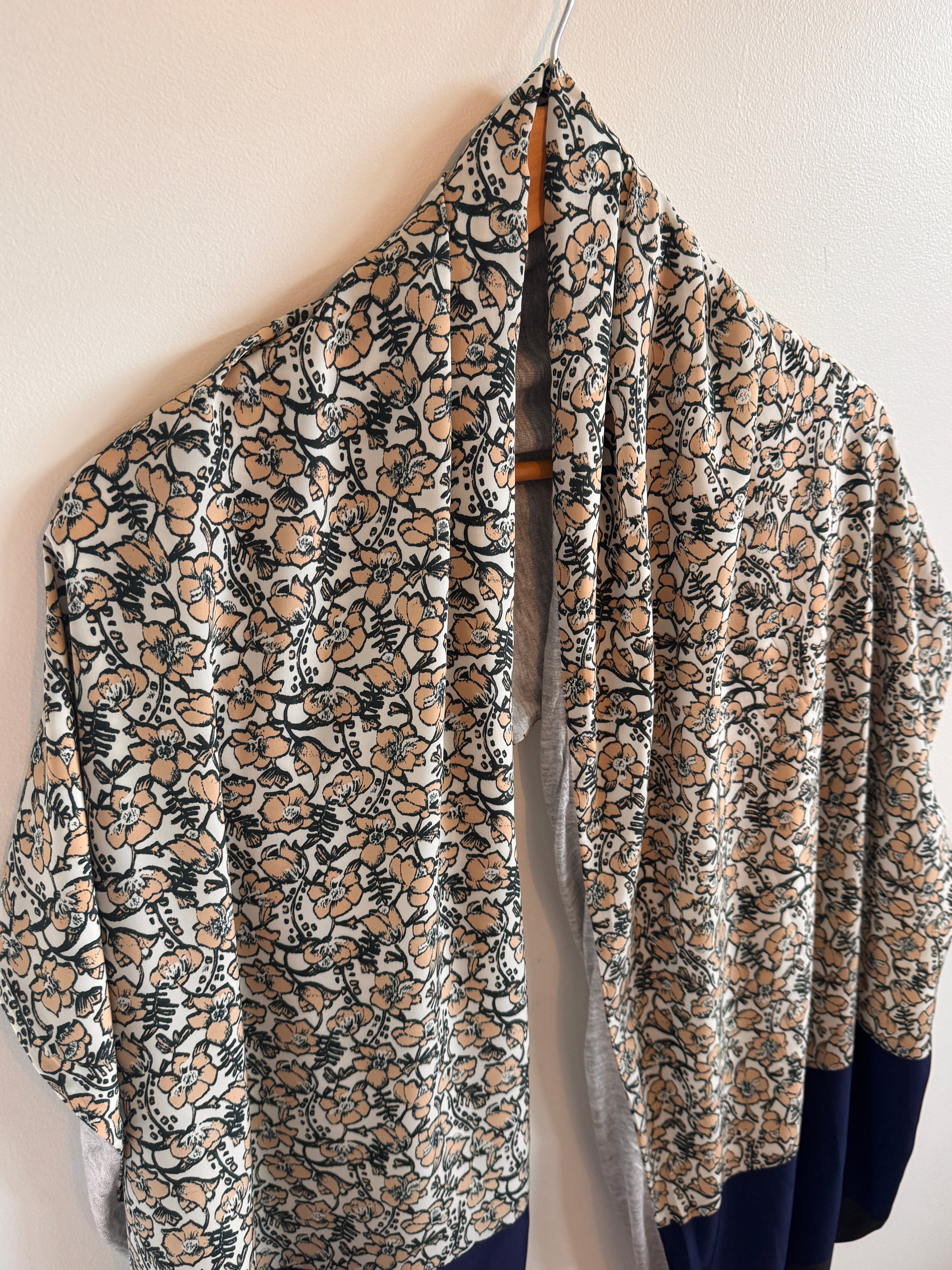 Folded floral-patterned fabric on a light background