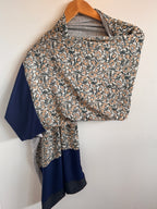 Floral-patterned bag with a blue interior on a white background