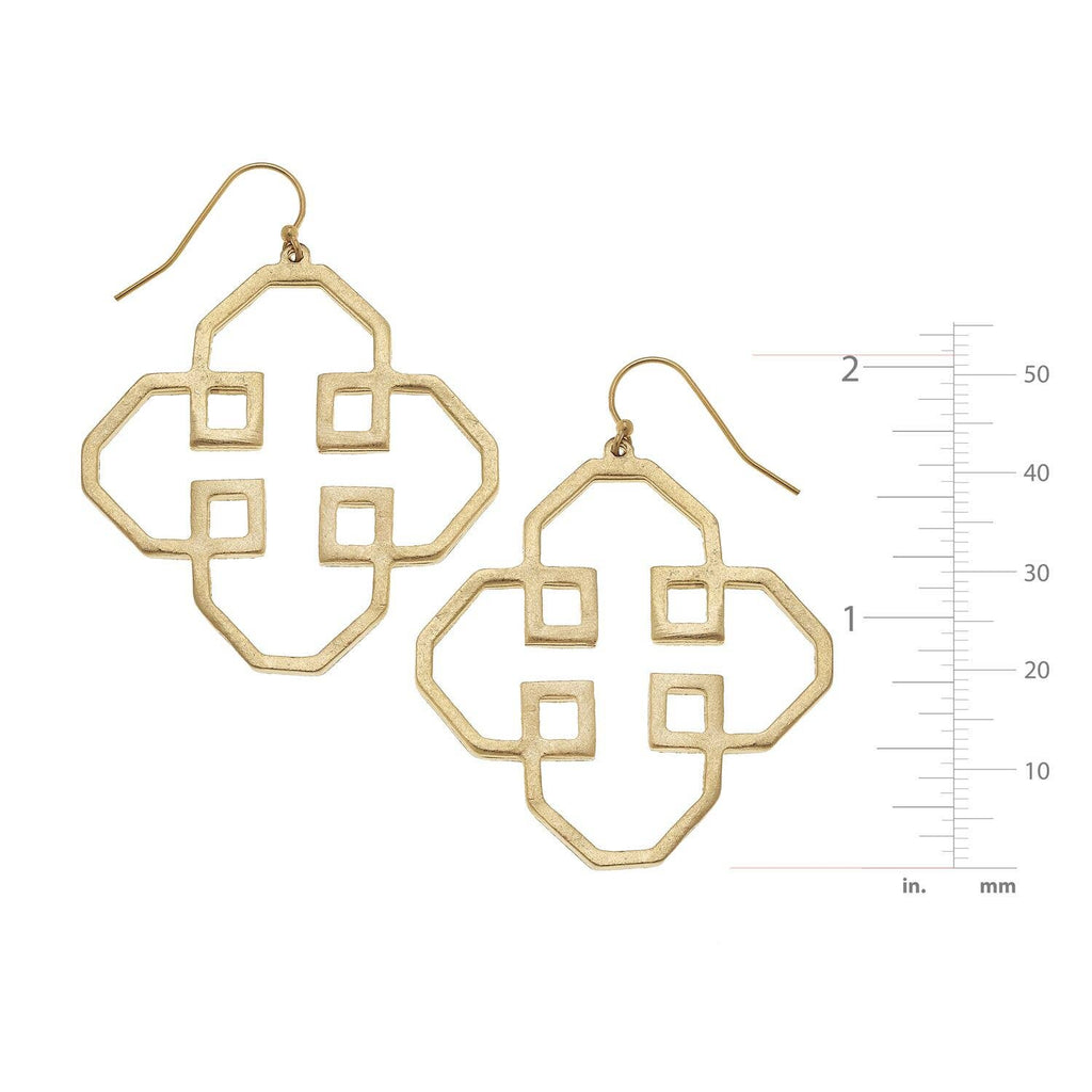 Gold geometric earrings with a measurement scale on a white background
