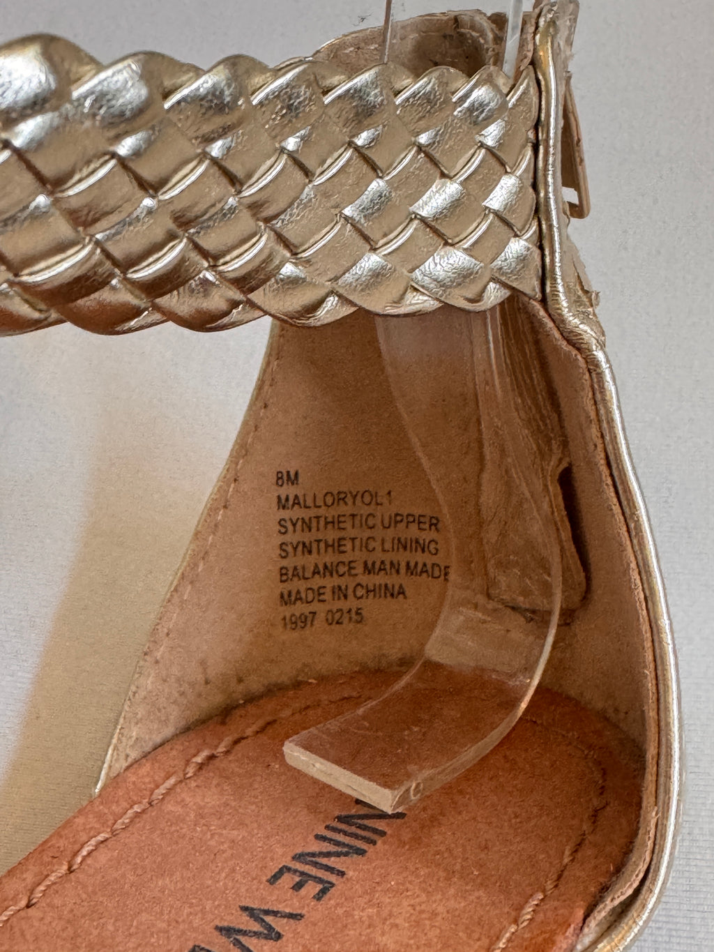 Size and style label inside a pair of gold leather women sandals