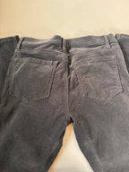 Close-up of gray pants with pockets on a beige background