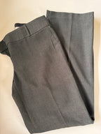 Gray pants folded on a beige surface