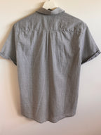 Short-sleeve shirt with a subtle pattern on a white background