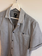 Striped shirt on a hanger with an H&M label.