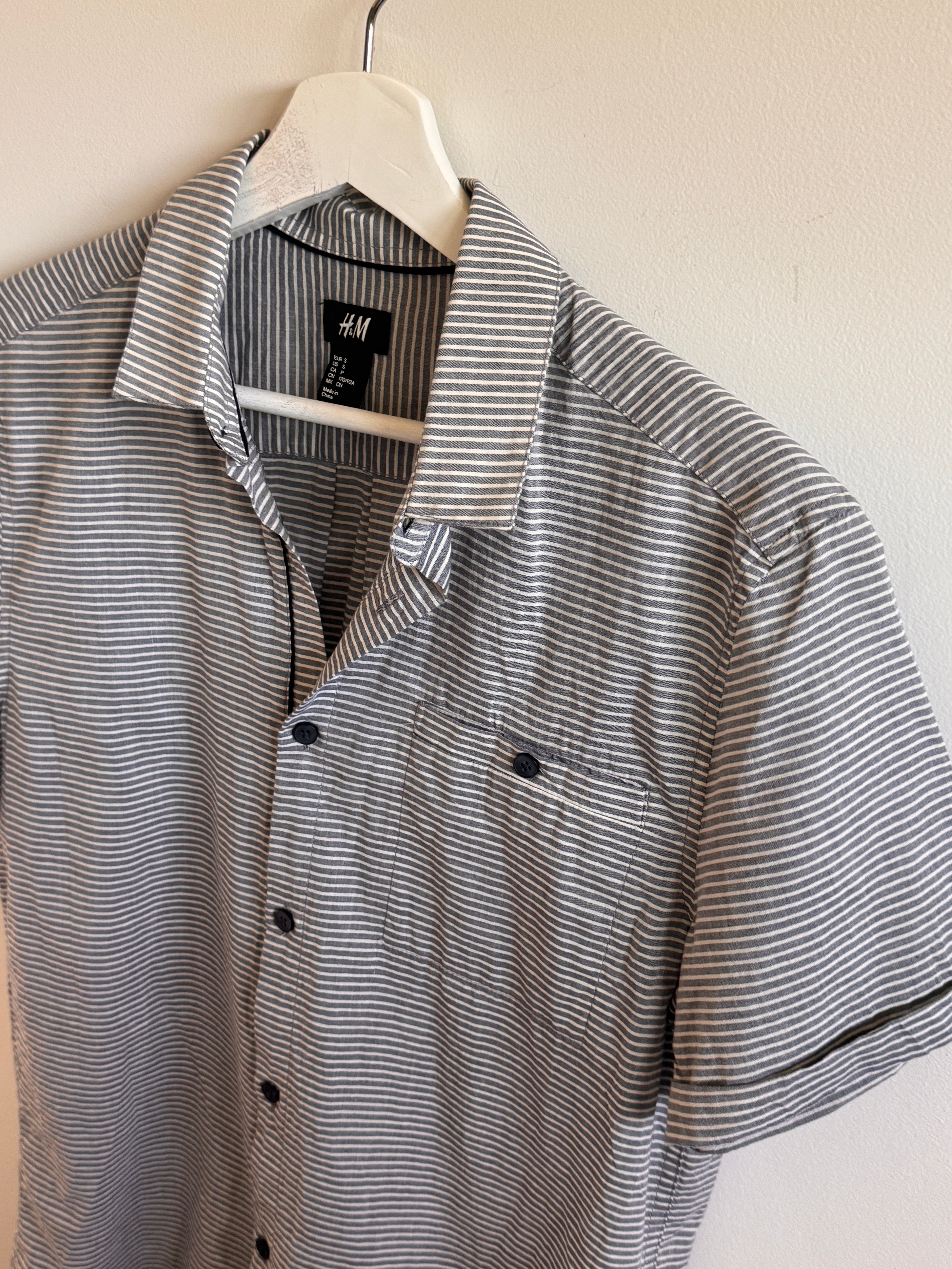 Striped shirt on a hanger with an H&M label.