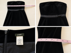 Black strapless dress with a gray belt, J.Crew tag, and measuring tape on a beige background.