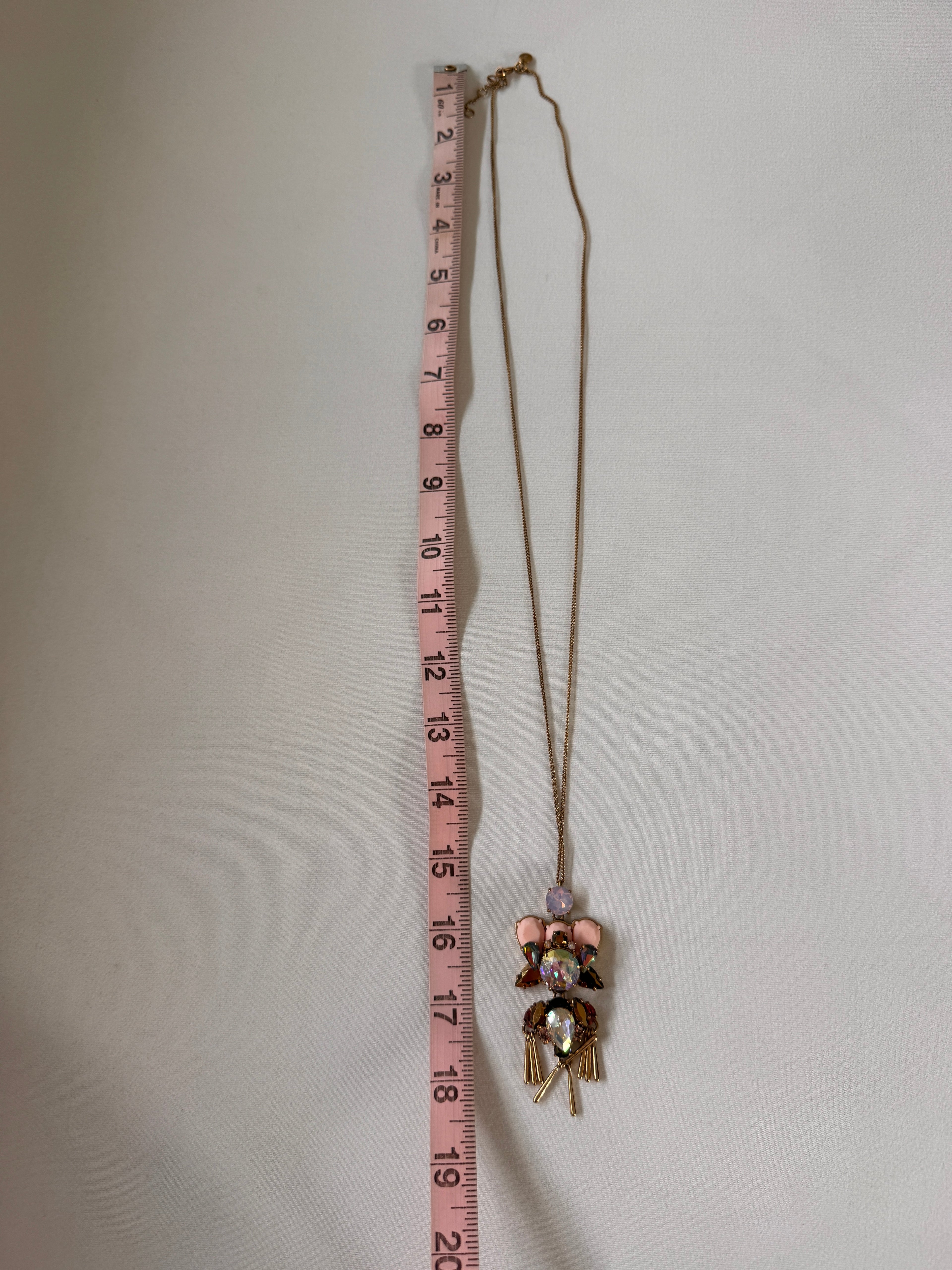 Floral headband with measuring tape for scale on a white background
